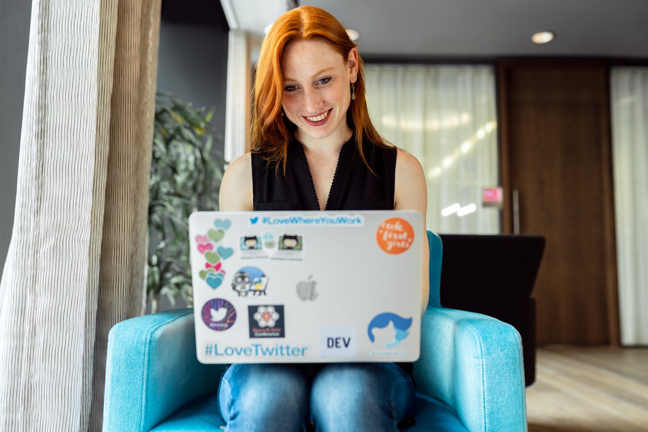 The Art of Drawing Readers In: Your attractive post title goes here Smiling woman engaged in remote work on a laptop at home office setting.